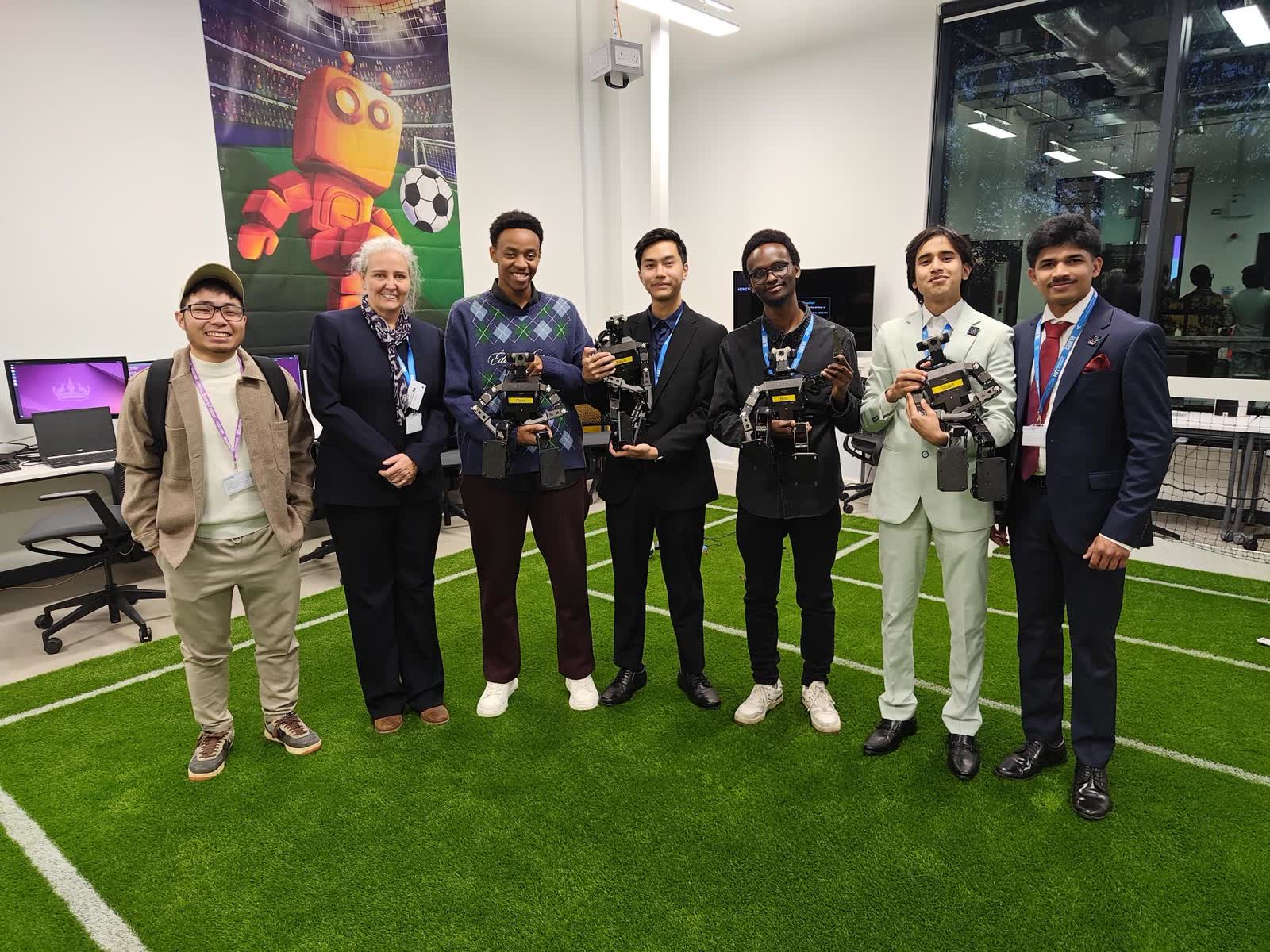 The STRIDE team on the pitch at Spectra with the OP3 robots after the demonstration